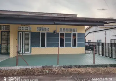 a small blue and yellow building with a porch at Homestay Zainab Sg Dua Mslim With 100mbps Wifi in Kepala Batas
