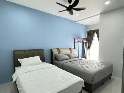 a bedroom with two beds and a ceiling fan at Forever Green cameron in Brinchang