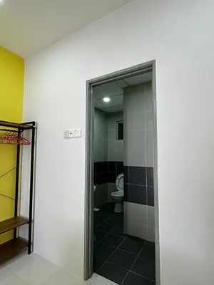 a bathroom with a toilet and a glass door at Forever Green cameron in Brinchang