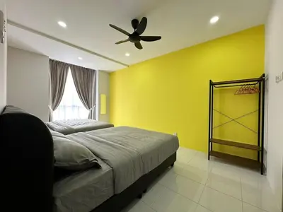 a bedroom with yellow walls and a bed with a ceiling fan at Forever Green cameron in Brinchang
