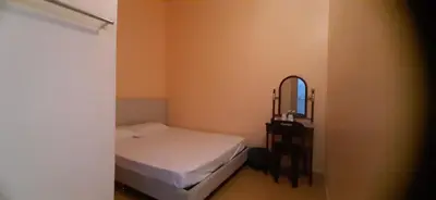 a small bedroom with a bed and a mirror at Wonderful Motel in Taiping