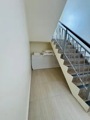 a room with a staircase with a bed underneath it at AYAAN PENTHOUSE at QUINTET 5 BED ROOM & ROOFTOP SKY DINING in Tanah Rata