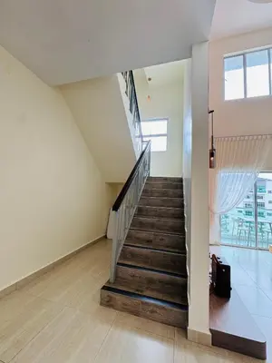 a staircase in a house with a stair case at AYAAN PENTHOUSE at QUINTET 5 BED ROOM & ROOFTOP SKY DINING in Tanah Rata
