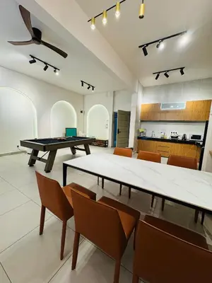 a room with two ping pong tables and chairs at AYAAN SNOOKERS HOUSE at QUINTET FREE PARKING and NETFLIX in Tanah Rata