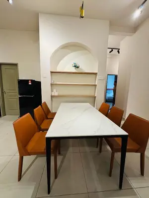 a dining room with a white table and orange chairs at AYAAN SNOOKERS HOUSE at QUINTET FREE PARKING and NETFLIX in Tanah Rata