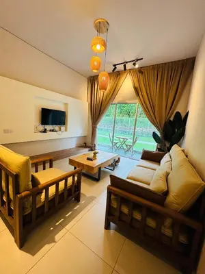 a living room with a couch and a table at AYAAN SNOOKERS HOUSE at QUINTET FREE PARKING and NETFLIX in Tanah Rata