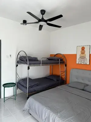 a bedroom with two bunk beds and a ceiling fan at Chillrex Homestay Just come over Chill & Relax in Brinchang