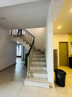 a staircase in a house with a yellow door at AYAAN PENTHOUSE at QUINTET ROOFTOP BBQ AND DINING with Mini Snookers in Tanah Rata