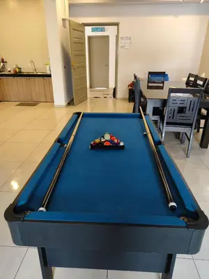 a pool table with two cuesticks on top of it at AYAAN PENTHOUSE at QUINTET ROOFTOP BBQ AND DINING with Mini Snookers in Tanah Rata