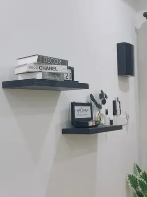 two shelves on the wall with books and a clock at 3Bedroom Landed Cozy Home Ipoh Netflix in Ipoh