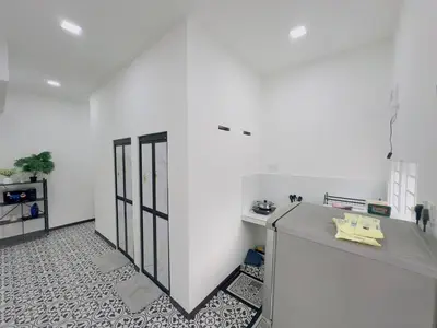 a kitchen with white walls and a counter in a room at 3Bedroom Landed Cozy Home Ipoh Netflix in Ipoh