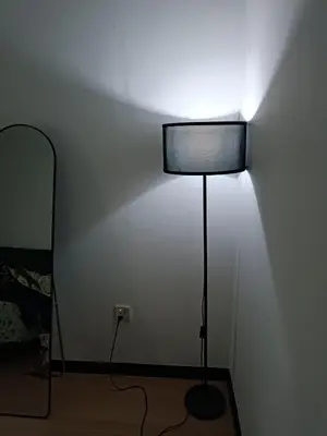 a lamp in a room with a white wall at 3Bedroom Landed Cozy Home Ipoh Netflix in Ipoh