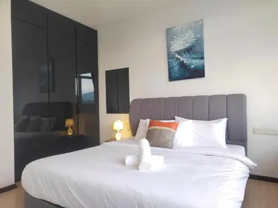 a bedroom with a large bed with white sheets at Spacious 1BR 118 Island Plaza 4pax in George Town