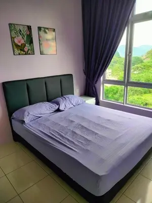 a bed in a bedroom with a large window at VS Homestay in Ipoh