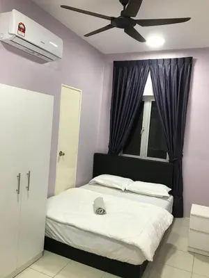 a bedroom with a bed with a ceiling fan at VS Homestay in Ipoh