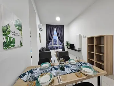 a table with plates on it in a living room at Ipoh Town, Anderson Residence in Ipoh