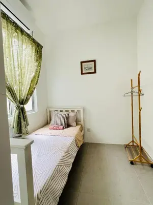 a small bedroom with a bed with a window at N&N Modern Apartment in Kampong Padang Meha