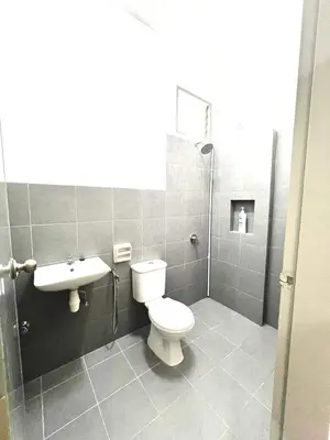 a bathroom with a toilet and a sink at N&N Modern Apartment in Kampong Padang Meha