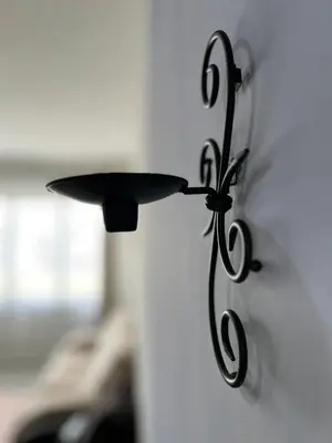 a black lamp hanging on a wall at N&N Modern Apartment in Kampong Padang Meha