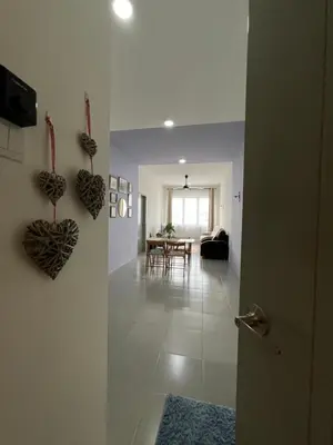 a hallway with a living room and a dining room at N&N Modern Apartment in Kampong Padang Meha