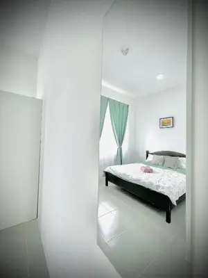 a white bedroom with a bed and a window at N&N Modern Apartment in Kampong Padang Meha