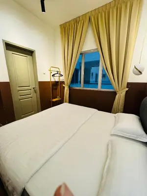 a bedroom with a large bed and a window at AYAAN QUINTET Green Valley with Free Parking in Tanah Rata