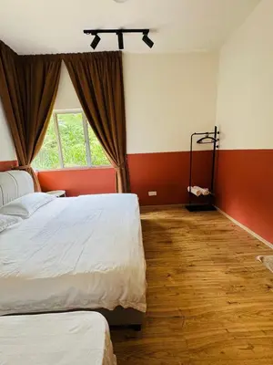 a bedroom with two beds and a window at AYAAN QUINTET Green Valley with Free Parking in Tanah Rata