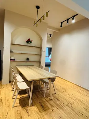 a dining room with a wooden table and chairs at AYAAN QUINTET Green Valley with Free Parking in Tanah Rata