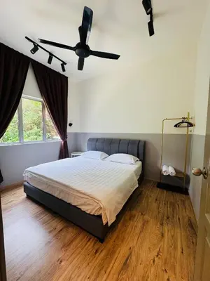 a bedroom with a bed and a ceiling fan at AYAAN QUINTET Green Valley with Free Parking in Tanah Rata