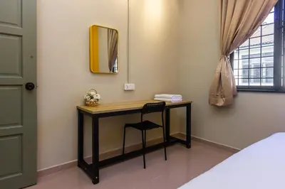 a room with a desk with a mirror and a chair at 13-Pax Vacation Retreats in Butterworth near Sunway Carnival in Perai