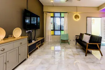 a living room with a couch and a table at 13-Pax Vacation Retreats in Butterworth near Sunway Carnival in Perai