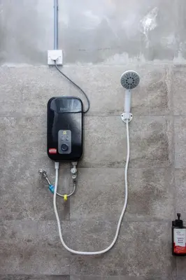a wall with a soap dispenser attached to a wall at 13-Pax Vacation Retreats in Butterworth near Sunway Carnival in Perai