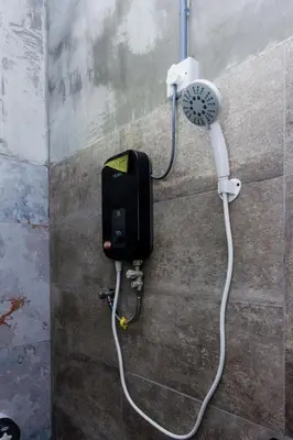 a shower with a blow dryer attached to a wall at 13-Pax Vacation Retreats in Butterworth near Sunway Carnival in Perai