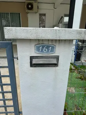a white mailbox with a clock on top of it at Cozy All Four Bedroom with Aircond Stay wifi and Netflix in Kampong Bota Road