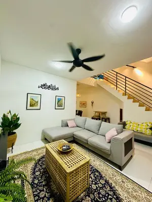 a living room with a couch and a ceiling fan at Cozy All Four Bedroom with Aircond Stay wifi and Netflix in Kampong Bota Road
