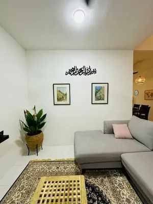 a living room with a couch and a plant at Cozy All Four Bedroom with Aircond Stay wifi and Netflix in Kampong Bota Road