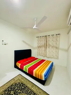 a colorful bed in a room with a window at Cozy All Four Bedroom with Aircond Stay wifi and Netflix in Kampong Bota Road