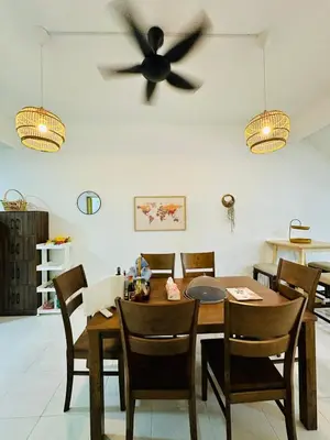 a dining room with a table and a ceiling fan at Cozy All Four Bedroom with Aircond Stay wifi and Netflix in Kampong Bota Road
