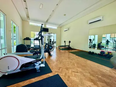 a gym with treadmills and machines in a room at Dreame Home by The Quay in George Town