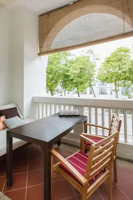 a dining room table and chairs on a balcony at Dreame Home by The Quay in George Town