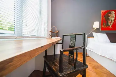 a bedroom with a wooden desk and a bed at Dreame Home by The Quay in George Town