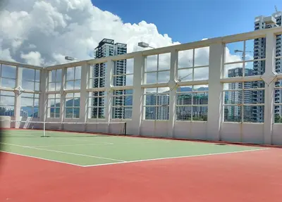 a tennis court in front of a building with tall buildings at Dreame Home by The Quay in George Town