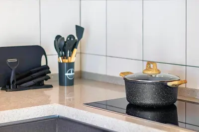 a pot on top of a stove in a kitchen at The Sun by Stellar ALV in Bayan Lepas