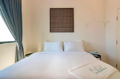 a bedroom with a large white bed and a window at The Sun by Stellar ALV in Bayan Lepas