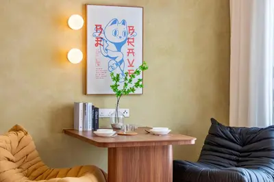 a living room with a table and two chairs at The Sun by Stellar ALV in Bayan Lepas