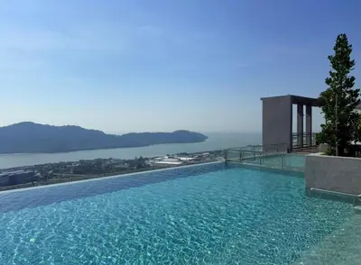 a large swimming pool with a view of the water at Iconic Regency by BNB4U in Bayan Lepas