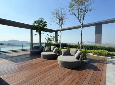 a deck with two couches and a view of the water at Iconic Regency by BNB4U in Bayan Lepas