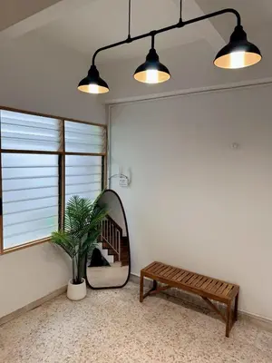 a living room with a mirror and a bench at W Home at Jalan Rangoon, George Town Penang in George Town