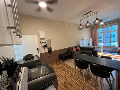 a living room with a table and a couch at The Anderson Ipoh AA1 Smart TV & 5G WiFi ready in Ipoh