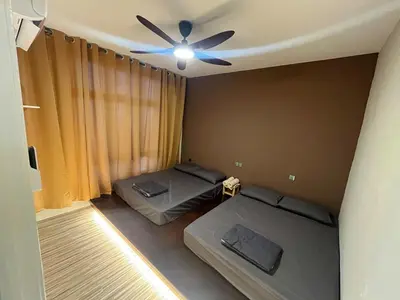 a room with two beds and a ceiling fan at The Anderson Ipoh AA1 Smart TV & 5G WiFi ready in Ipoh